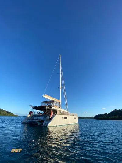 Samadhi Yacht Photos Pics 2019 Lagoon 560 S2 catamaran sailing on calm blue waters under clear sky.