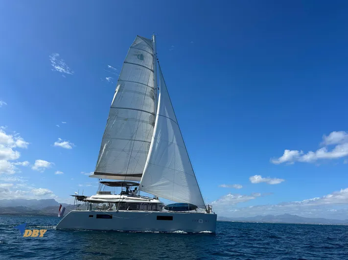 Samadhi Yacht Photos Pics 2019 Lagoon 560 S2 catamaran sailing on open sea under clear blue sky.