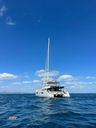 Samadhi Yacht Photos Pics 2019 Lagoon 560 S2 catamaran sailing on open sea under clear blue sky.