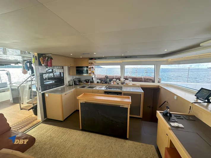 Samadhi Yacht Photos Pics Luxurious interior of 2019 Lagoon 560 S2 yacht with modern kitchen and panoramic windows.