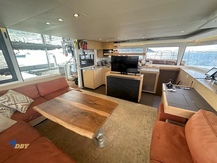 Samadhi Yacht Photos Pics Luxurious interior of 2019 Lagoon 560 S2 yacht with modern furnishings and ocean view.