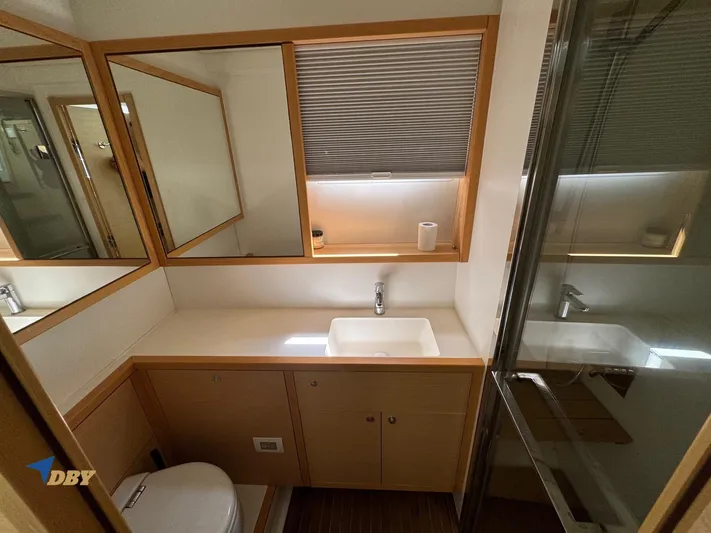 Samadhi Yacht Photos Pics Modern bathroom in 2019 Lagoon 560 S2 yacht with sink, mirror, and shower.