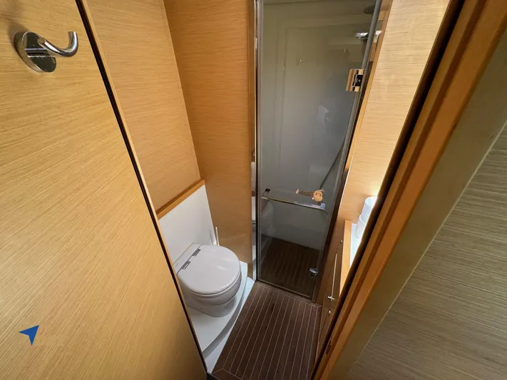 Samadhi Yacht Photos Pics Bathroom interior of 2019 Lagoon 560 S2 yacht with wooden accents and modern fixtures.