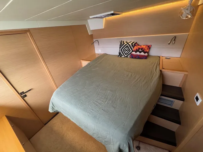 Samadhi Yacht Photos Pics Luxurious bedroom interior of 2019 Lagoon 560 S2 yacht with modern design and cozy bedding.