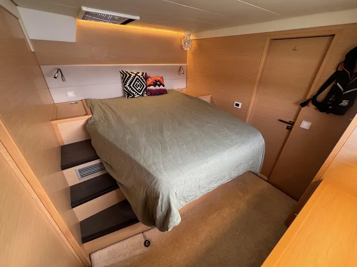 Samadhi Yacht Photos Pics Luxurious bedroom interior of 2019 Lagoon 560 S2 yacht with modern design and cozy bedding.