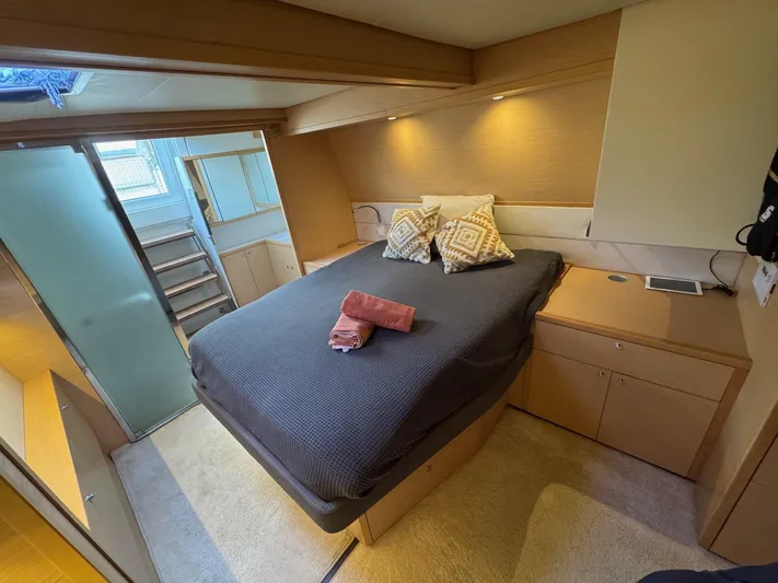 Samadhi Yacht Photos Pics Luxurious bedroom interior of 2019 Lagoon 560 S2 yacht with modern design and cozy bedding.