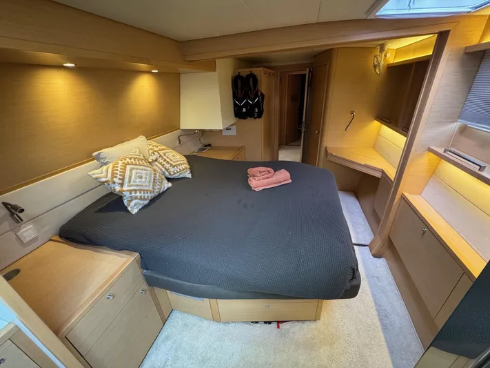 Samadhi Yacht Photos Pics Luxurious cabin interior of 2019 Lagoon 560 S2 yacht with cozy bed and modern furnishings.