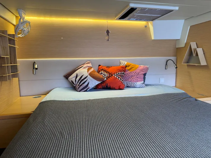 Samadhi Yacht Photos Pics Luxurious cabin interior of 2019 Lagoon 560 S2 yacht with stylish bedding and ambient lighting.