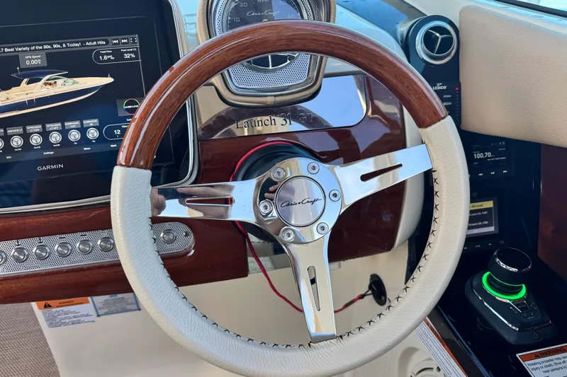  Yacht Photos Pics 2021 Chris-Craft Launch 31 GT dashboard with wooden steering wheel and Garmin display.