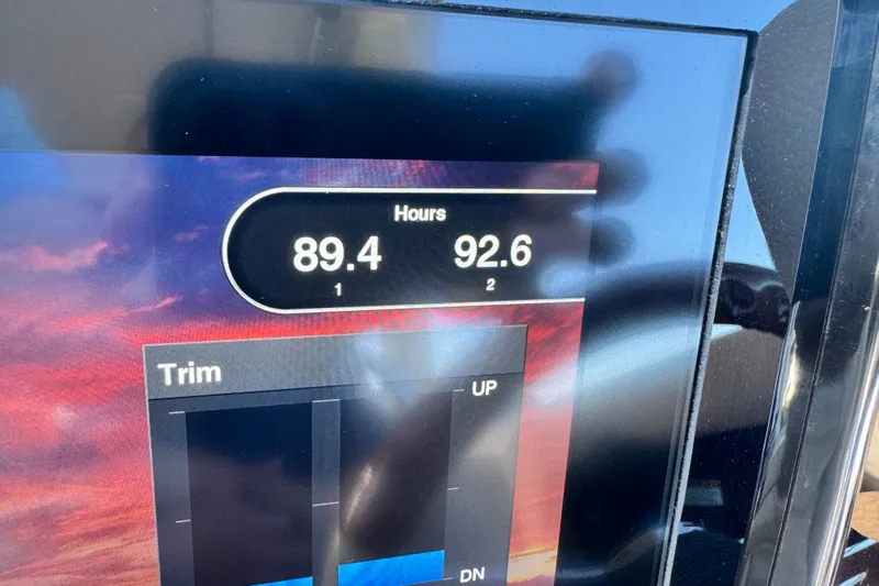  Yacht Photos Pics Dashboard display of a 2021 Chris-Craft Launch 31 GT showing engine hours and trim settings.