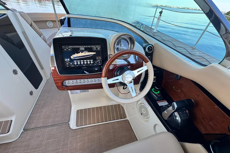  Yacht Photos Pics 2021 Chris-Craft Launch 31 GT dashboard with steering wheel and navigation display.