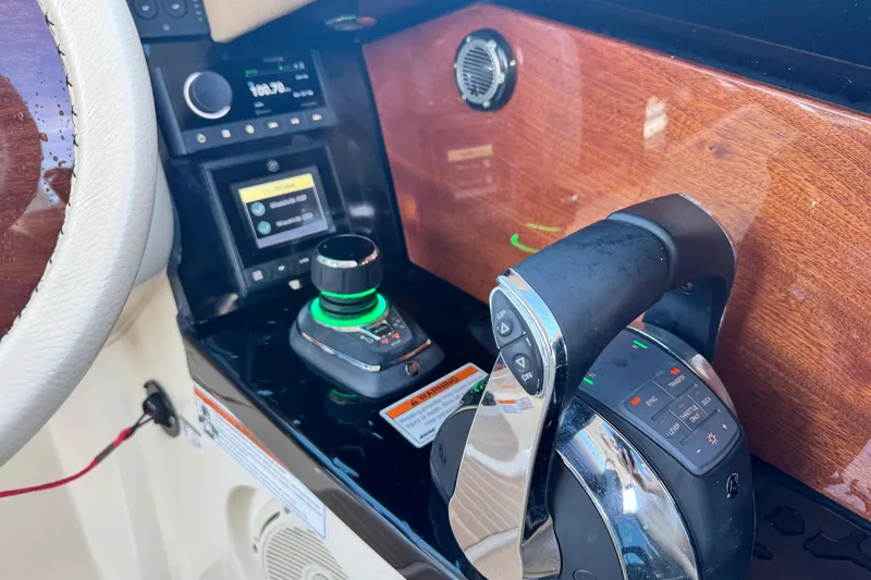  Yacht Photos Pics 2021 Chris-Craft Launch 31 GT dashboard with controls and wood paneling.