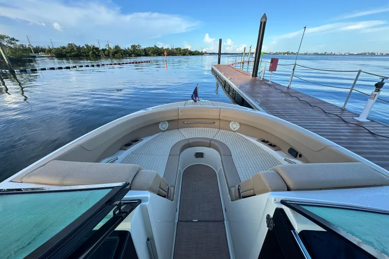  Yacht Photos Pics 2021 Chris-Craft Launch 31 GT boat docked by a serene waterfront.
