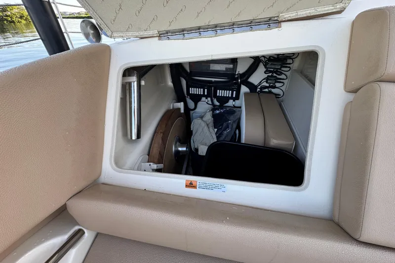  Yacht Photos Pics Interior storage compartment of 2021 Chris-Craft Launch 31 GT boat, featuring beige upholstery.