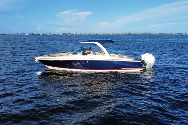  Yacht Photos Pics 2021 Chris-Craft Launch 31 GT boat cruising on open water under clear blue skies.