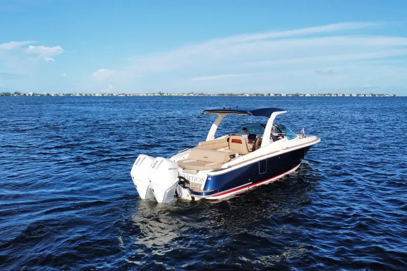  Yacht Photos Pics 2021 Chris-Craft Launch 31 GT boat cruising on open water under clear blue skies.
