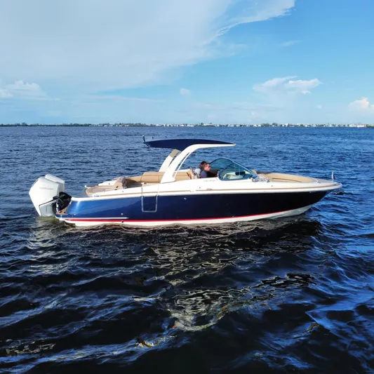 Yacht Photos Pics 2021 Chris-Craft Launch 31 GT boat cruising on open water under a clear blue sky.