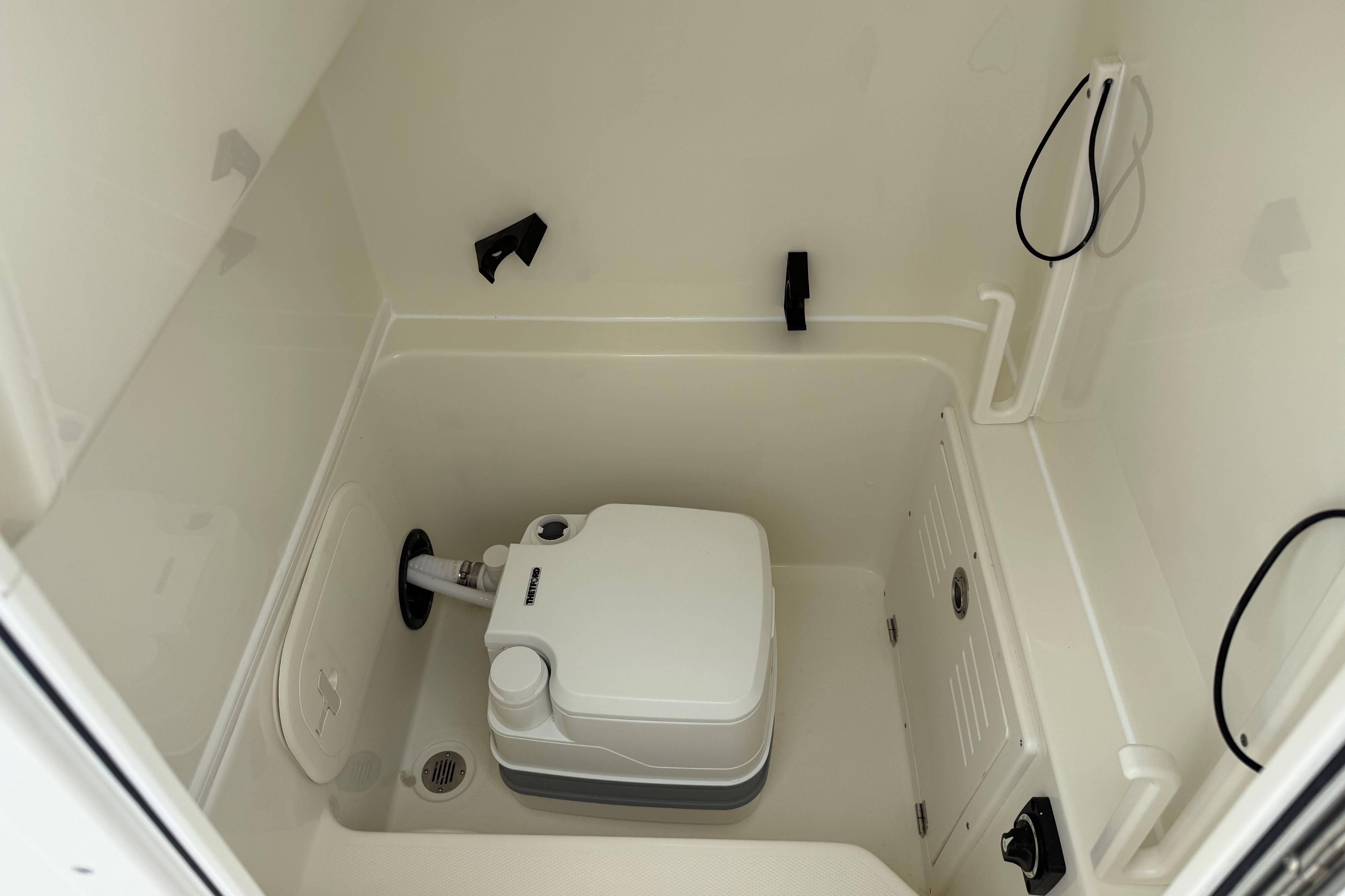 2026 Pathfinder 2400 TRS boat interior with compact marine toilet setup.