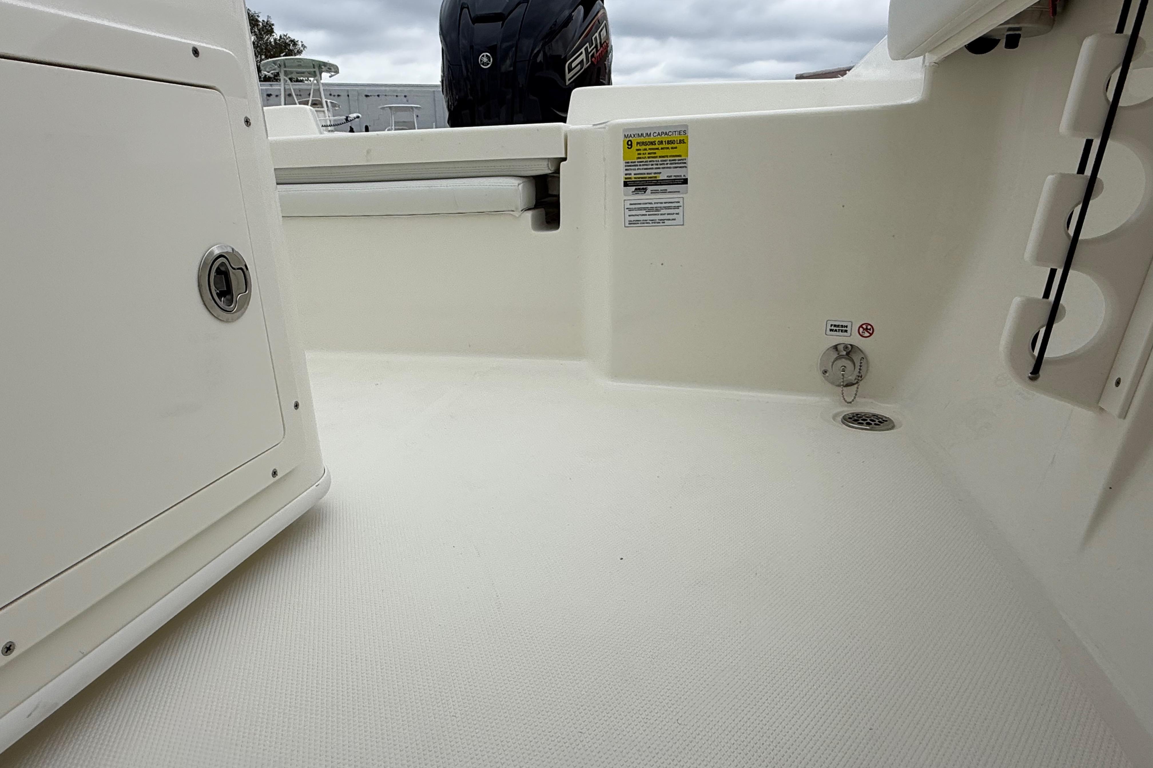 2026 Pathfinder 2400 TRS boat interior, featuring storage compartments and safety labels.