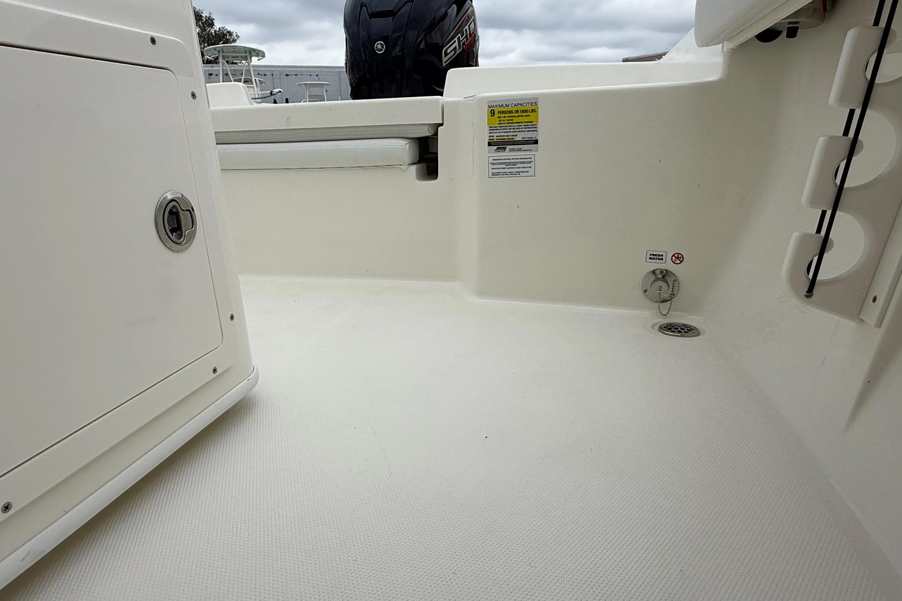 2026 Pathfinder 2400 TRS boat interior, featuring storage compartments and safety labels.