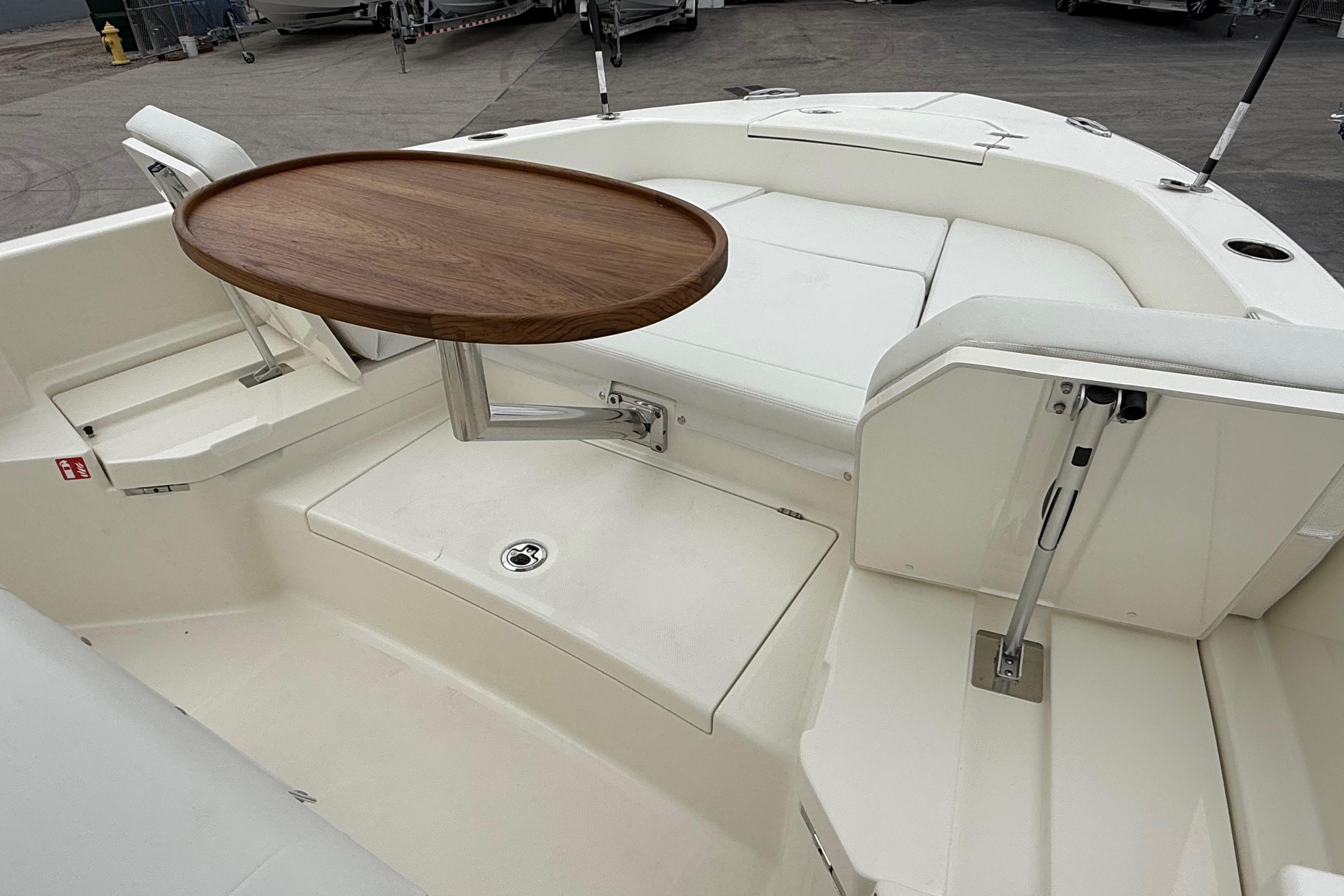 2026 Pathfinder 2400 TRS boat interior with wooden table and white seating.