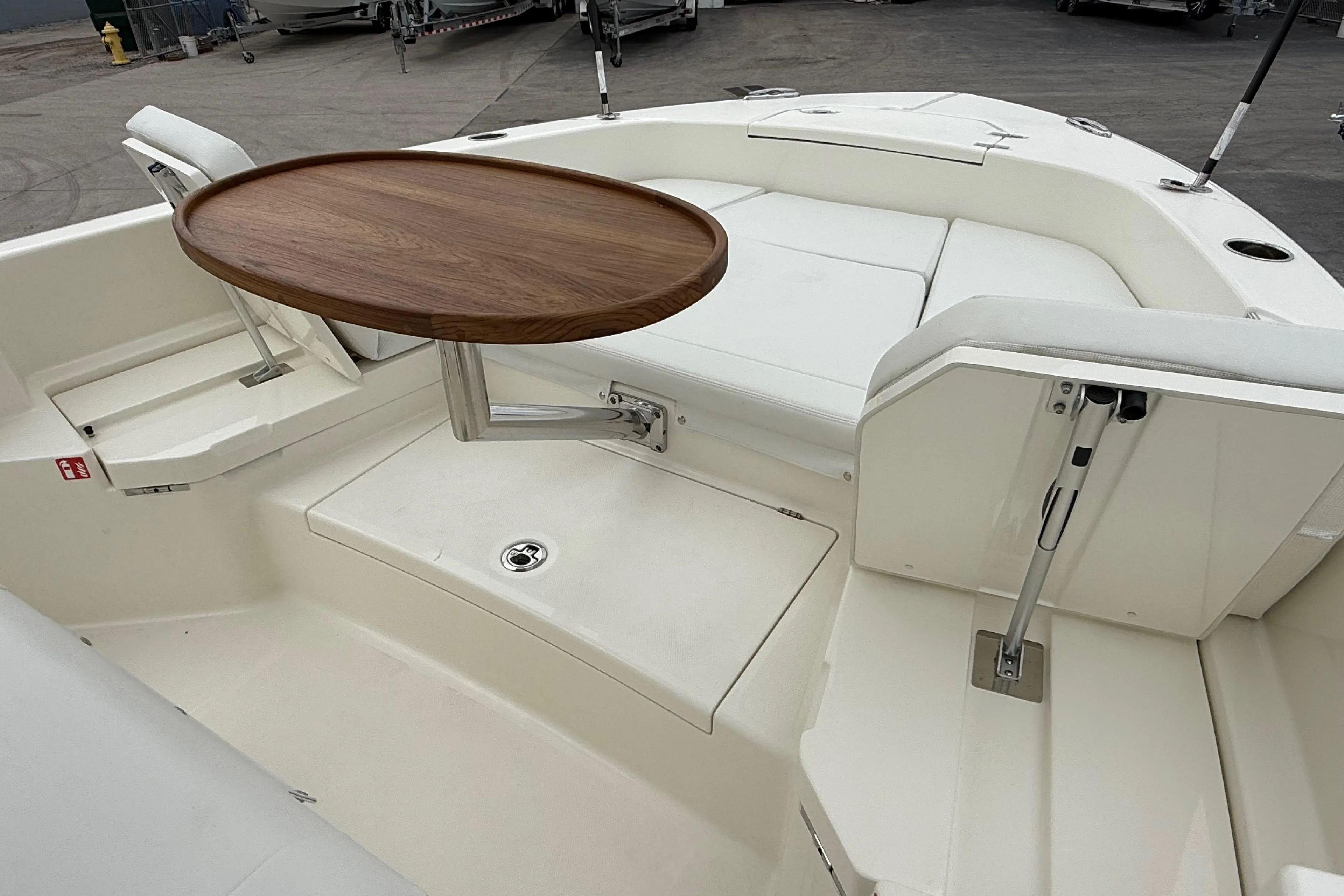 2026 Pathfinder 2400 TRS boat interior with wooden table and white seating.