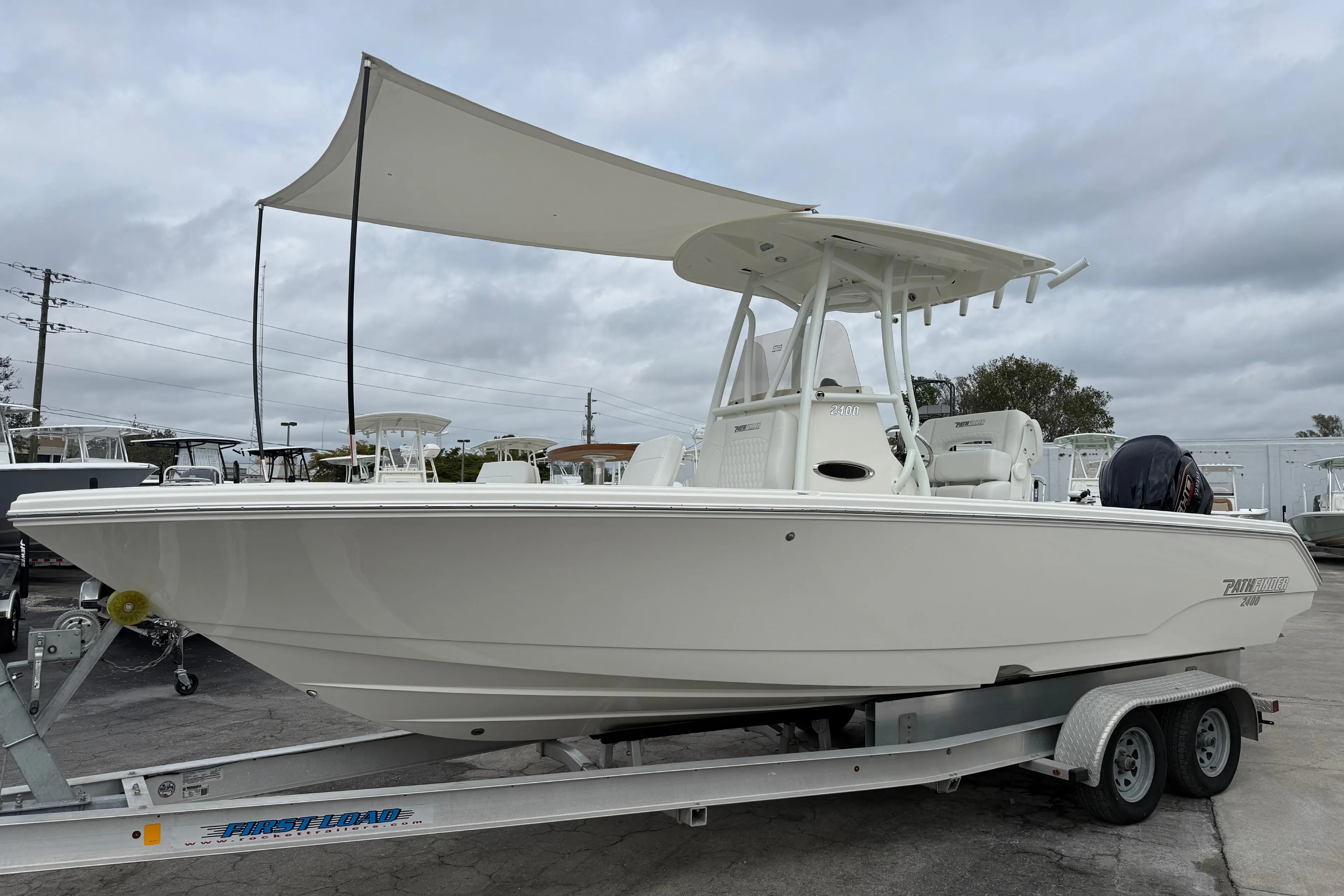 2026 Pathfinder 2400 TRS boat on trailer, featuring a sleek design and canopy.
