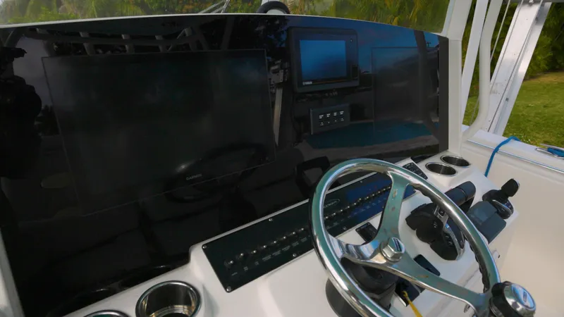  Yacht Photos Pics 2022 Cobia 350 Center Console dashboard with steering wheel and electronic displays.