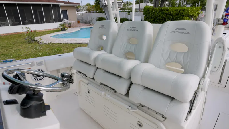  Yacht Photos Pics 2022 Cobia 350 Center Console boat with luxurious seating and steering wheel.