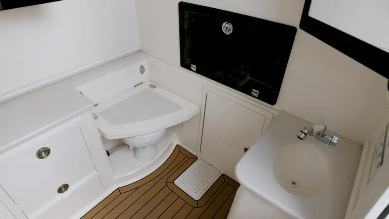  Yacht Photos Pics 2022 Cobia 350 Center Console bathroom with sink and toilet, featuring wood-style flooring.
