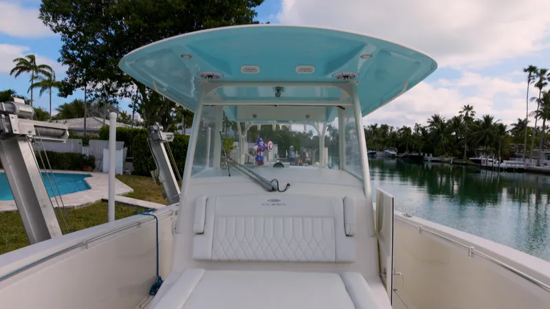  Yacht Photos Pics 2022 Cobia 350 Center Console boat docked by a serene waterfront.