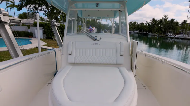  Yacht Photos Pics 2022 Cobia 350 Center Console boat with spacious seating, docked by a serene waterfront.