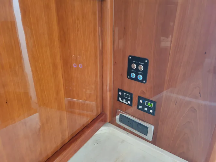  Yacht Photos Pics Control panel on 2016 Intrepid 475 Sport Yacht with wood finish and digital displays.