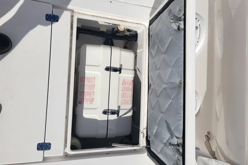  Yacht Photos Pics Storage compartment on a 2016 Intrepid 475 Sport Yacht, featuring a secured white container.