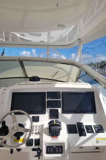  Yacht Photos Pics 2016 Intrepid 475 Sport Yacht helm with dual screens and controls, under clear skies.