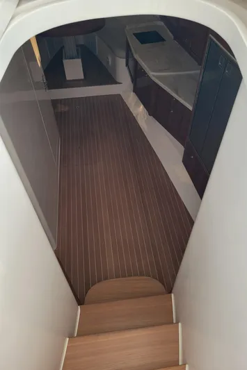  Yacht Photos Pics Interior view of 2016 Intrepid 475 Sport Yacht with wooden flooring and modern cabinetry.