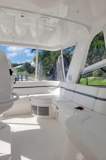  Yacht Photos Pics Interior of 2016 Intrepid 475 Sport Yacht with white seating and large windows.