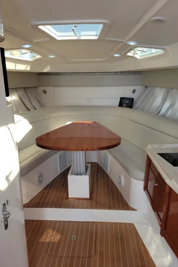  Yacht Photos Pics Interior of 2016 Intrepid 475 Sport Yacht with elegant seating and wooden table.