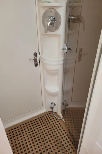  Yacht Photos Pics Shower area in 2016 Intrepid 475 Sport Yacht with wooden floor and modern fixtures.