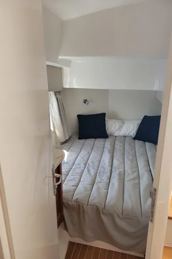  Yacht Photos Pics Cozy cabin interior of 2016 Intrepid 475 Sport Yacht with bed and pillows.