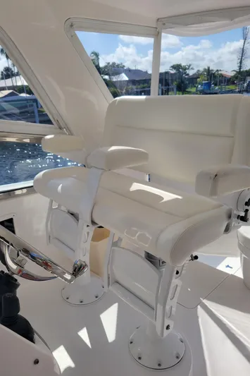  Yacht Photos Pics 2016 Intrepid 475 Sport Yacht interior with white seating and steering wheel, dockside view.