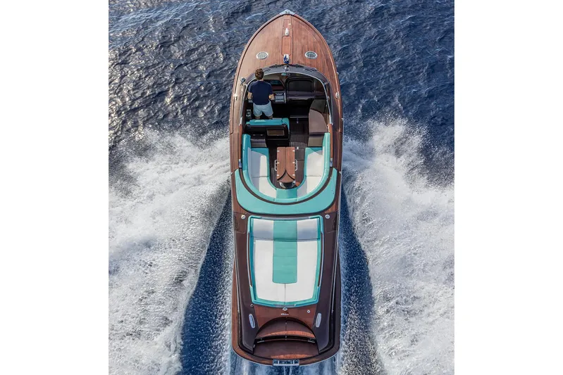 Bacio Yacht Photos Pics 2023 Riva Anniversario boat cruising on open water, top view.