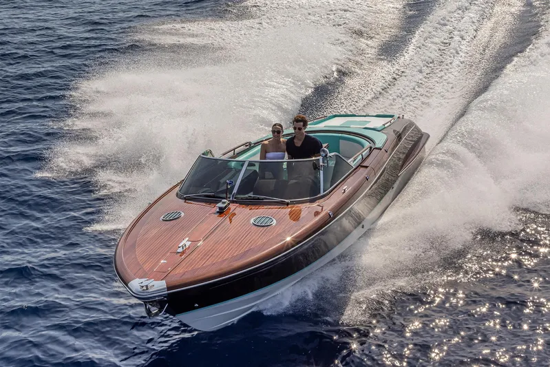 Bacio Yacht Photos Pics 2023 Riva Anniversario speedboat cruising on open water, showcasing sleek design and elegance.