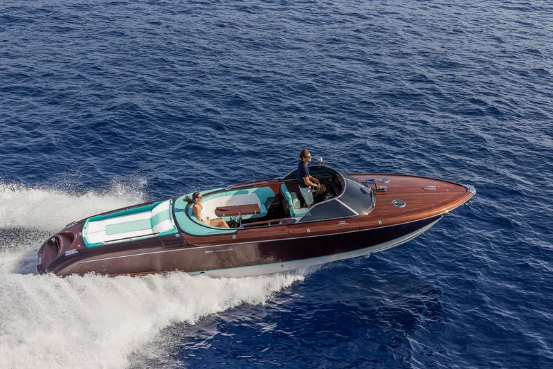 Bacio Yacht Photos Pics 2023 Riva Anniversario luxury boat cruising on open water.