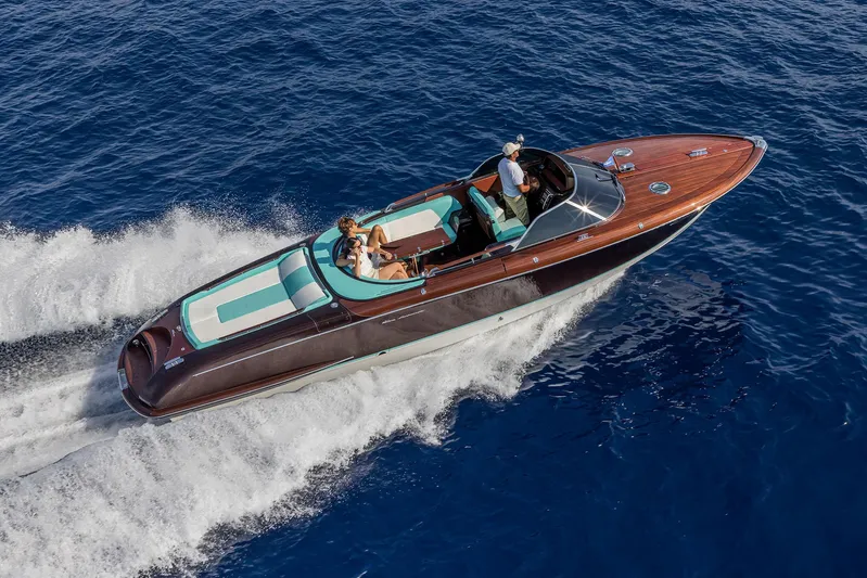 Bacio Yacht Photos Pics 2023 Riva Anniversario luxury boat cruising on blue ocean waters.