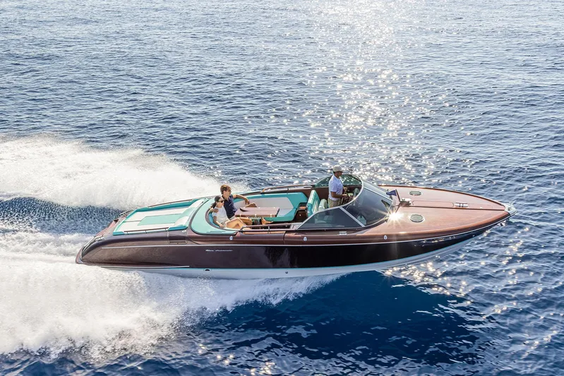 Bacio Yacht Photos Pics 2023 Riva Anniversario luxury boat cruising on open water, showcasing sleek design and elegance.