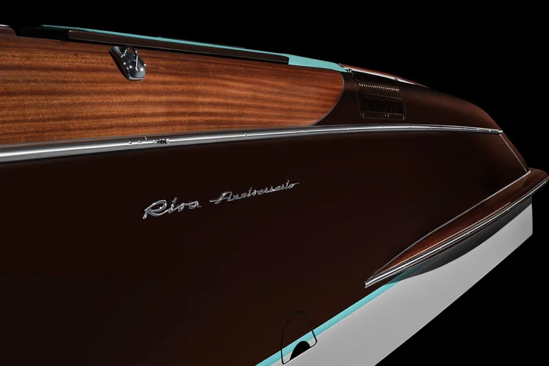 Bacio Yacht Photos Pics 2023 Riva Anniversario boat, elegant wood finish, sleek design, side view.