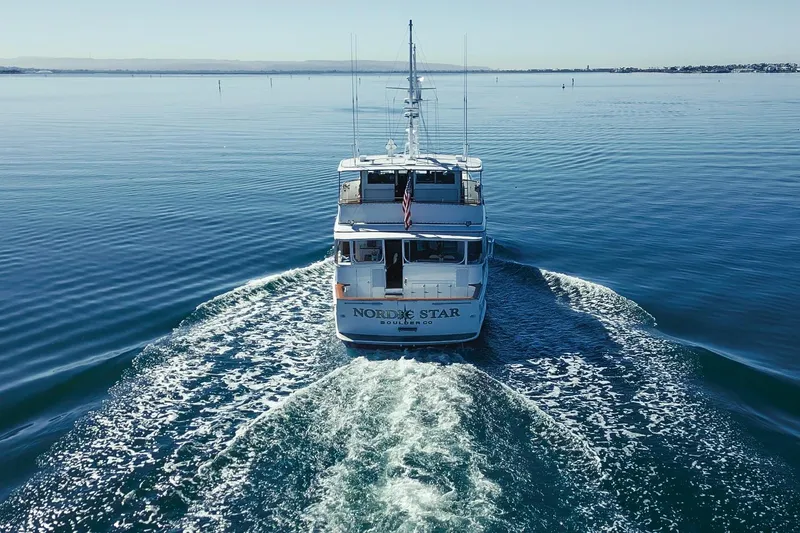 Nordic Star Yacht Photos Pics Custom 1969 Hargrave yacht cruising on calm waters, rear view.