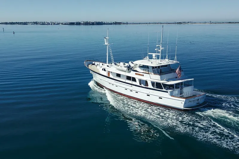Nordic Star Yacht Photos Pics Custom 1969 Hargrave yacht cruising on calm blue waters, displaying American flag.