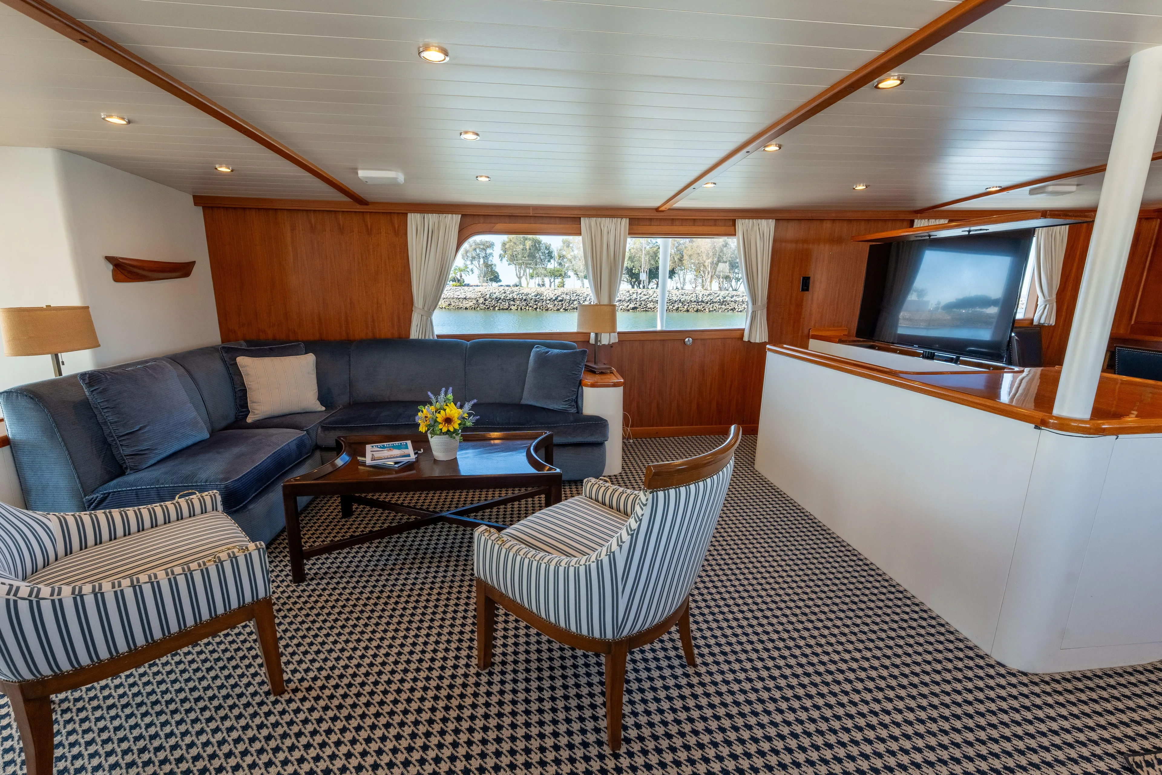 Luxurious 1969 Custom Hargrave yacht interior with elegant seating and large windows.